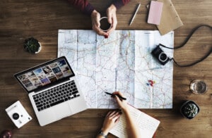 A traveller planning a trip with a map, representing the process of booking a stay