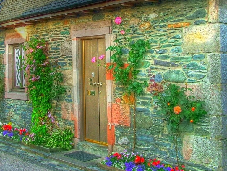 A charming stone cottage with a welcoming front door, similar in feel to The Old Post Office