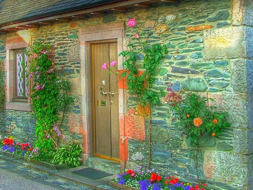 A charming stone cottage with a welcoming front door, similar in feel to The Old Post Office