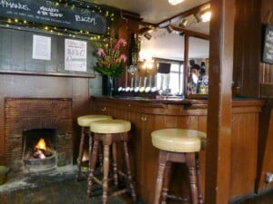 Cosy pub interior with an open fire, the kind of village local near Chatton